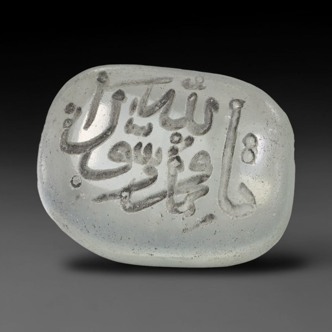 Early Vintage Islamic White Glass Calligraphic Intaglio Seal Cabochon (Post 1900 CE), 87BX: This early vintage glass intaglio seal cabochon draws from enduring Islamic seal-making traditions, formed from translucent pale glass with a smoothly rounded polished surface. The face features caref