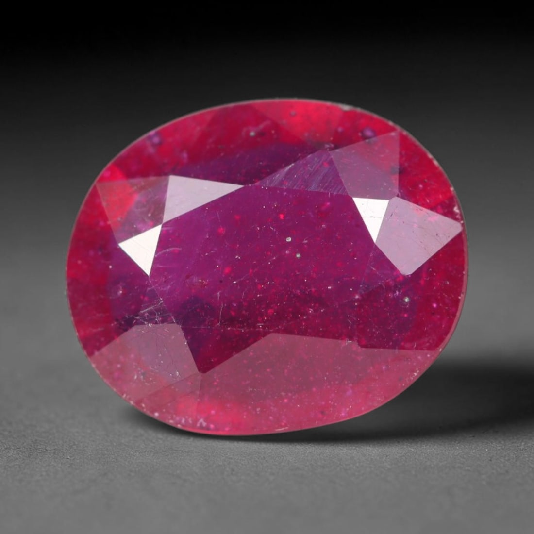 3.74ct Natural Madagascar Vivid Magenta Red Ruby Loose Gemstone, 50BA: This vivid magenta-hued Madagascar ruby boasts rich saturated red-pink saturation scattered with tiny fine mineral specks and distinct two-phase fluid bubble inclusions throughout its translucent crys
