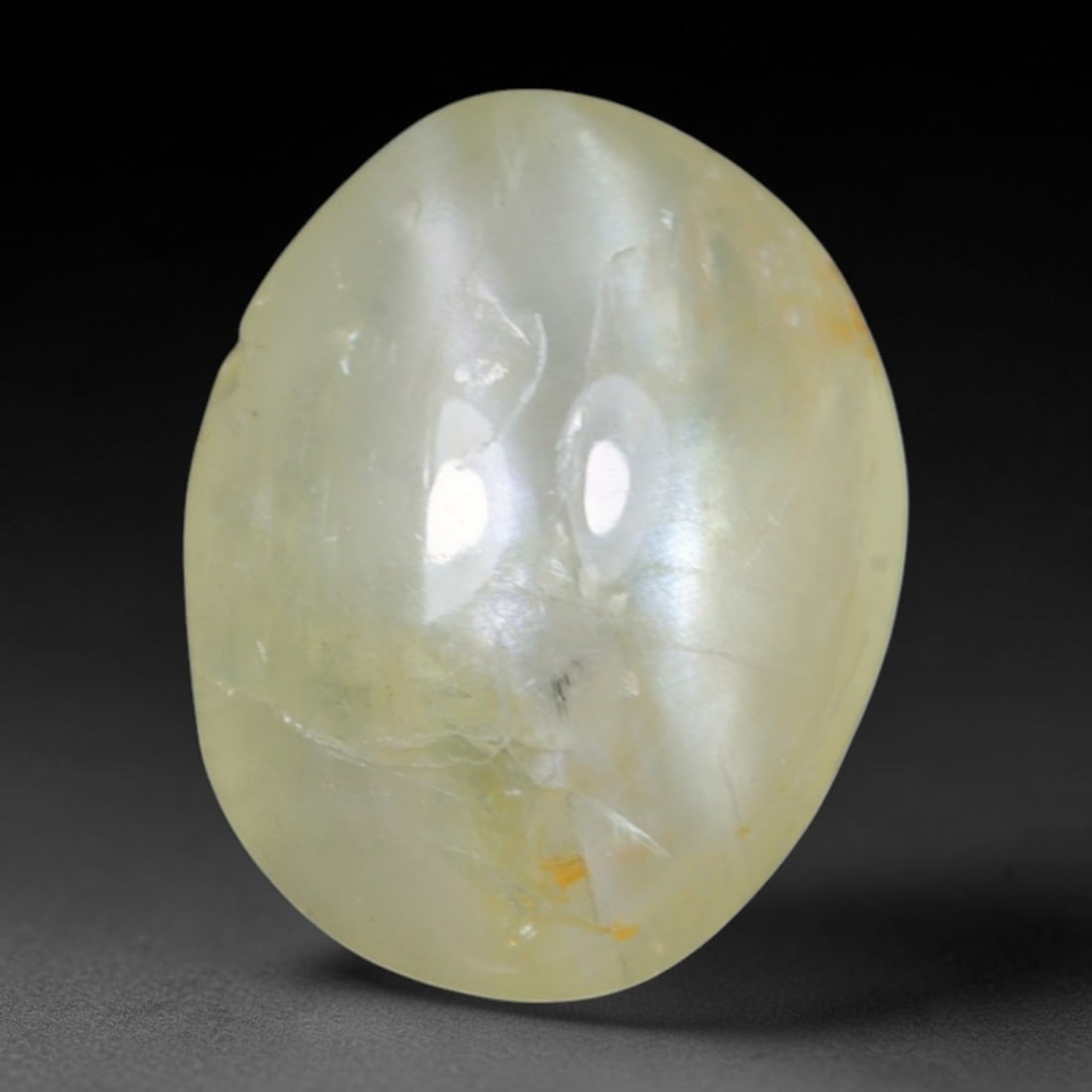 1.58 Carats Natural Ceylon Chrysoberyl Cat's Eye Loose Gemstone, 92AK: This polished Ceylon chrysoberyl cabochon displays a sharp, distinct silvery chatoyant band running across its smooth surface, formed by dense aligned microscopic rutile inclusions inherent to genuine