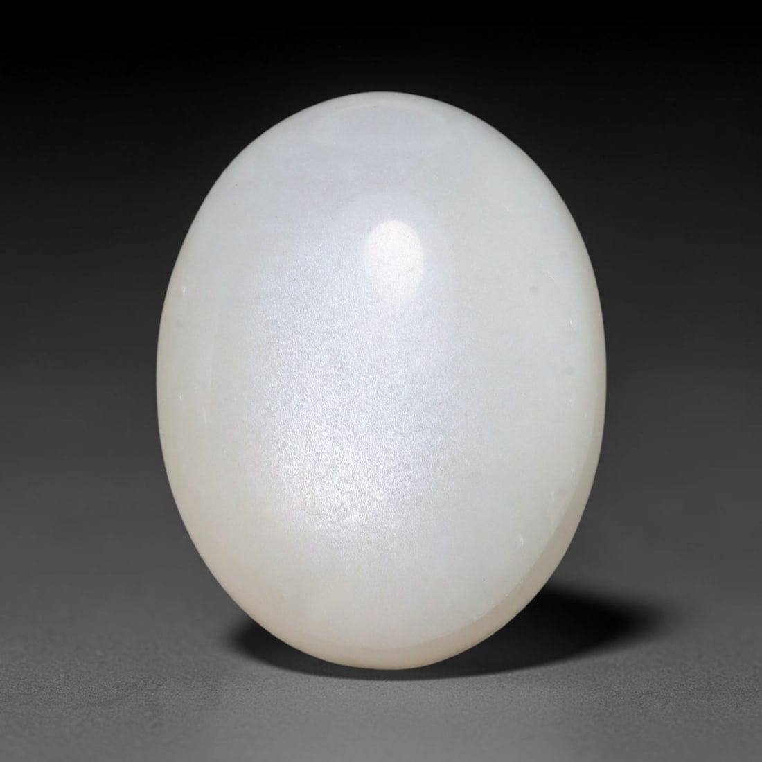 23.24ct Natural Ceylon White Moonstone Cabochon Loose Gemstone, 12FY: This natural Ceylon moonstone cabochon carries a milky white body showcasing classic adularescence. Fine mineral inclusions are visible within the gem. Dimensions measure 21x16x9mm, mined in Sri Lanka