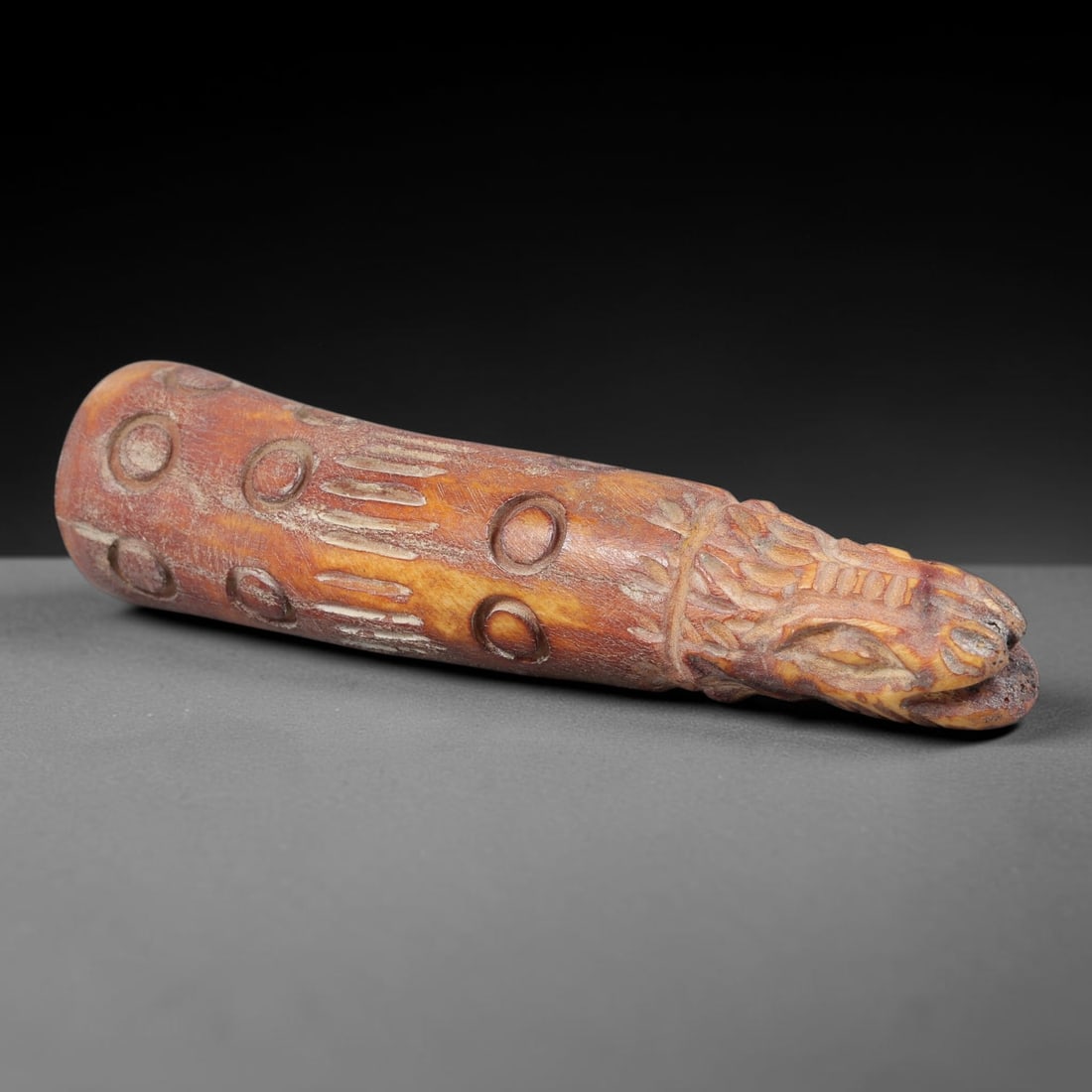 Ancient Medieval Carved Bone Zoomorphic Beast Head Finial, 42BX: Carved from naturally aged patinated animal bone, this elongated tapered finial features a detailed stylized canine/wolf beast head terminal at the apex with incised facial detail, fur texture line ca