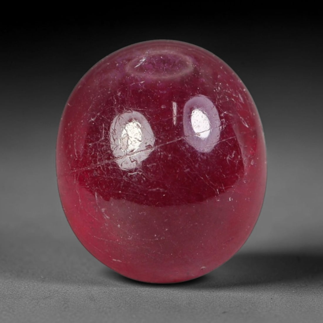 6.60ct Natural Mozambican Deep Crimson Red Ruby Cabochon Loose Gemstone, 23AS: This smoothly polished cabochon ruby holds a rich deep crimson red body hue, covered with fine natural surface fracturing and tiny scattered mineral specks across its domed polished surface within its