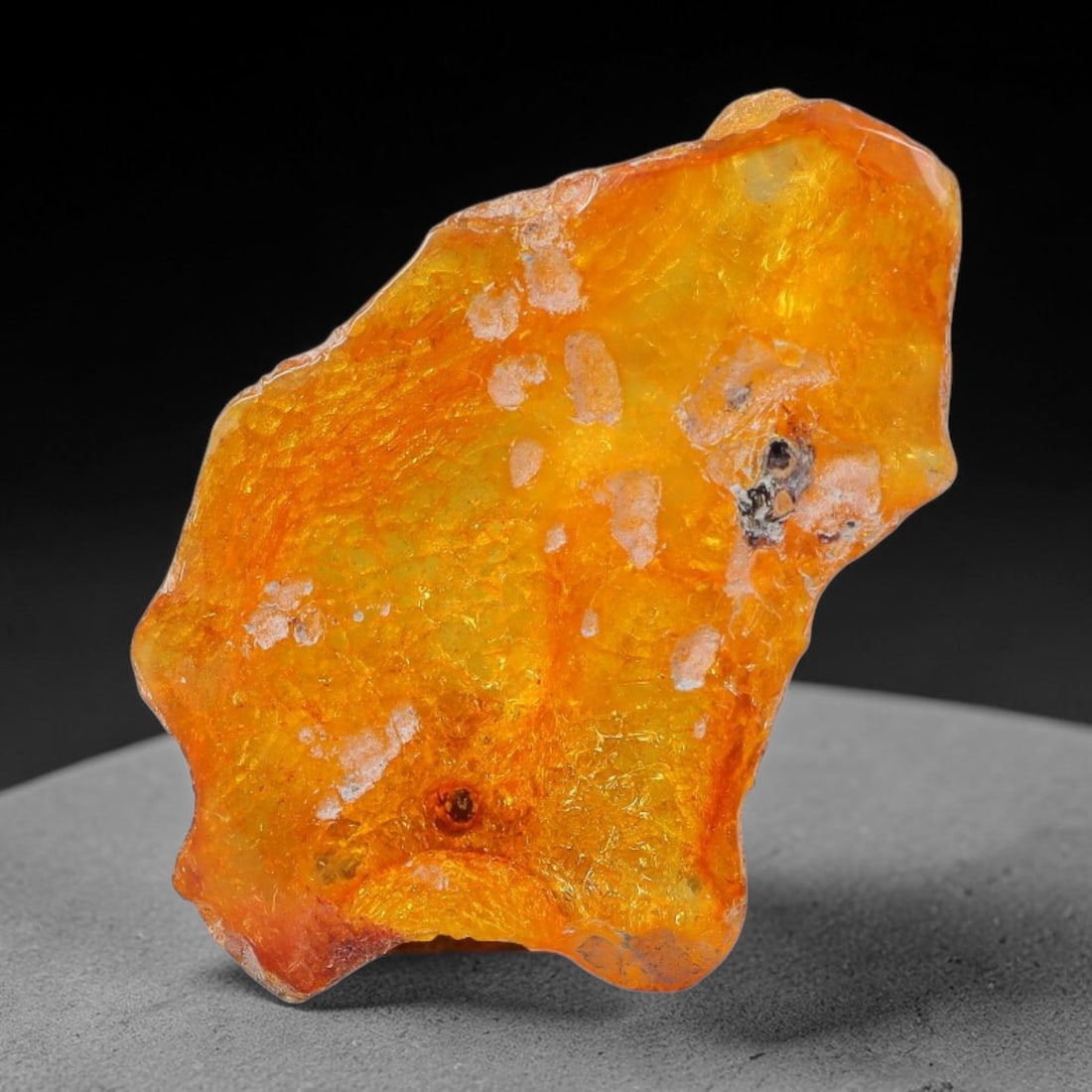 17ct Natural Baltic Polished Loose Freeform Amber Gemstone, 46EB: This smoothly polished freeform amber piece carries warm translucent organic clarity with fine natural fossil flecks and tiny mineral inclusions suspended throughout its 34x21mm flowing unstructured s