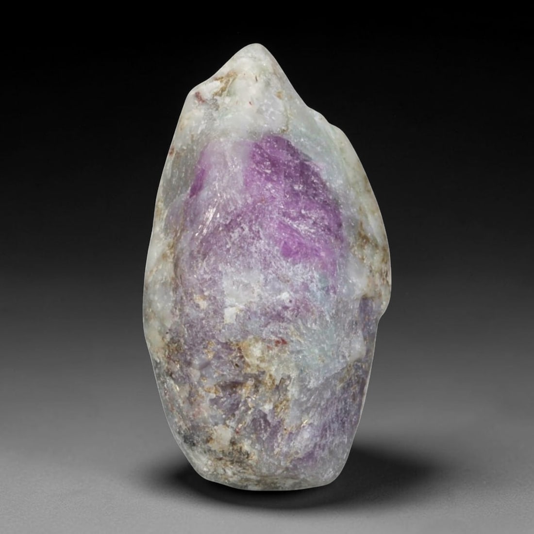 26.90ct Natural Mauritania Ruby Rough (Unheated), 77AM: This unheated Mauritania ruby rough is a striking natural crystal specimen, featuring a rich, saturated magenta hue with subtle purple undertones that deepen toward the core. The rough's rugged, natur