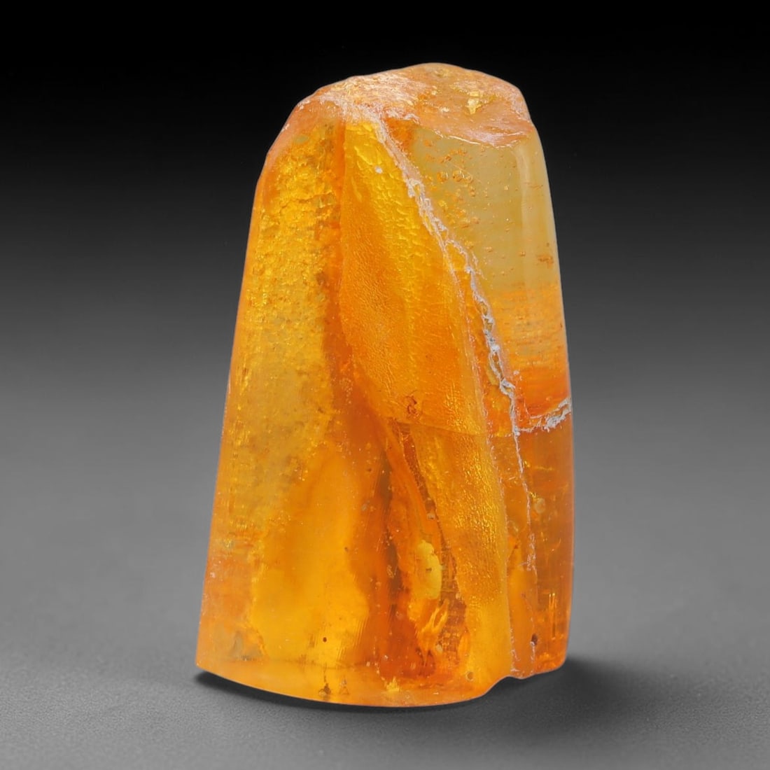 20.76ct Natural Baltic Polished Loose Freeform Amber Gemstone, 68AT: This smoothly polished freeform amber piece carries warm translucent organic clarity with fine natural fossil flecks and tiny mineral inclusions suspended throughout its 28x19mm flowing unstructured s