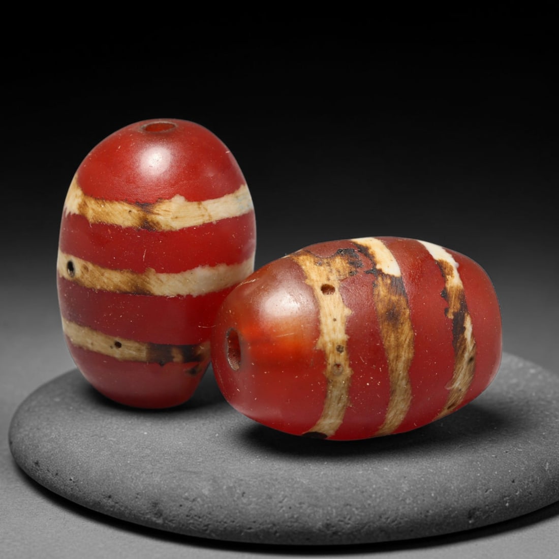 Ancient Medieval Burmese Pagan & Ava Kingdoms Etched Carnelian Barrel Beads (849-1555 CE), 31FY: This pair of antique etched carnelian barrel beads originates from the Medieval Burmese Pagan & Ava Kingdoms, whose etched carnelian bead craft continued to produce trade specimens circulated widely t