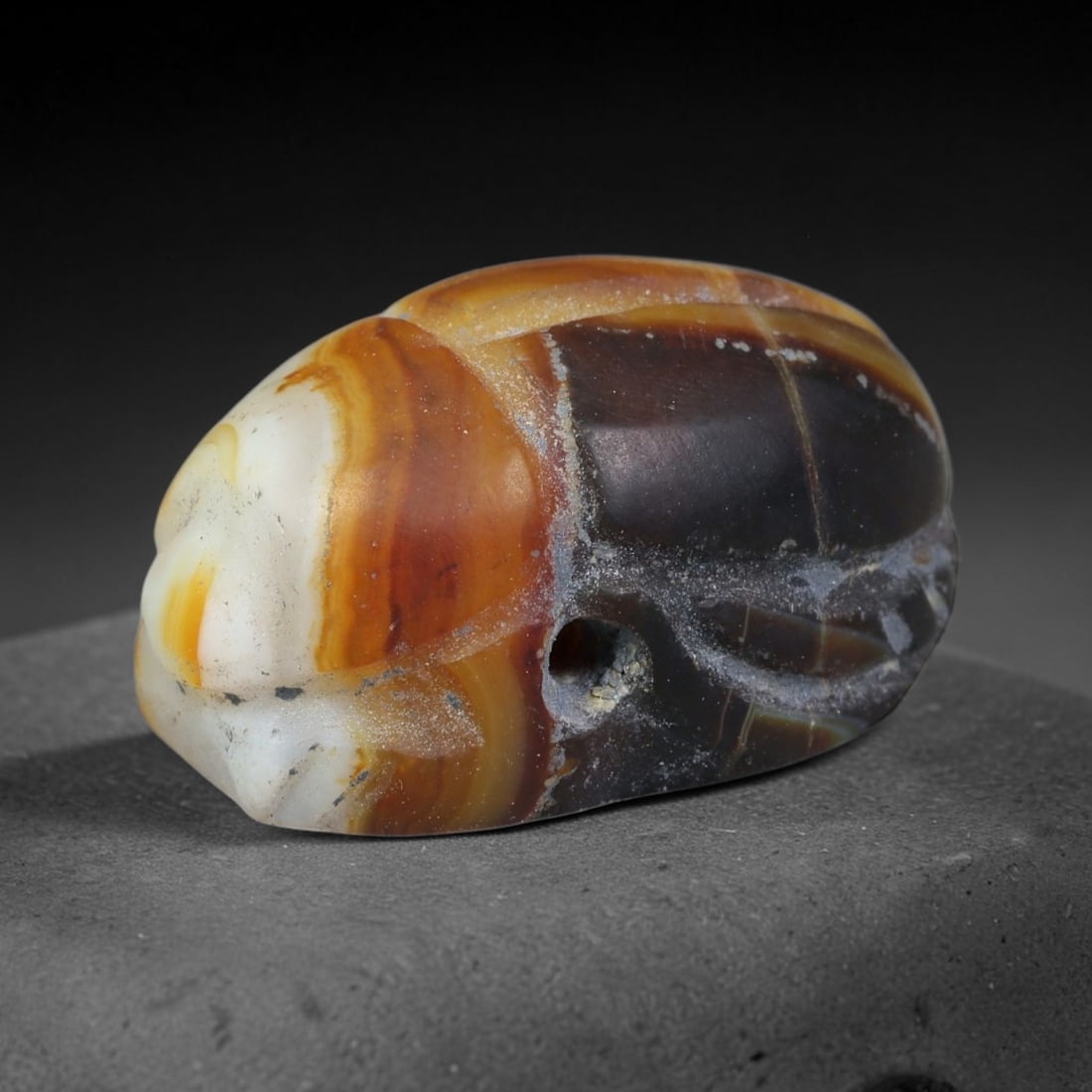 Ancient Pharaonic Egyptian Agate Scarab Amulet Bead (3100 BCE-30 CE), 47FV: This antique scarab amulet bead is carved from natural agate, originating from Pharaonic Egyptian culture. Scarabs were sacred protective talismans closely linked to rebirth and eternal life within an