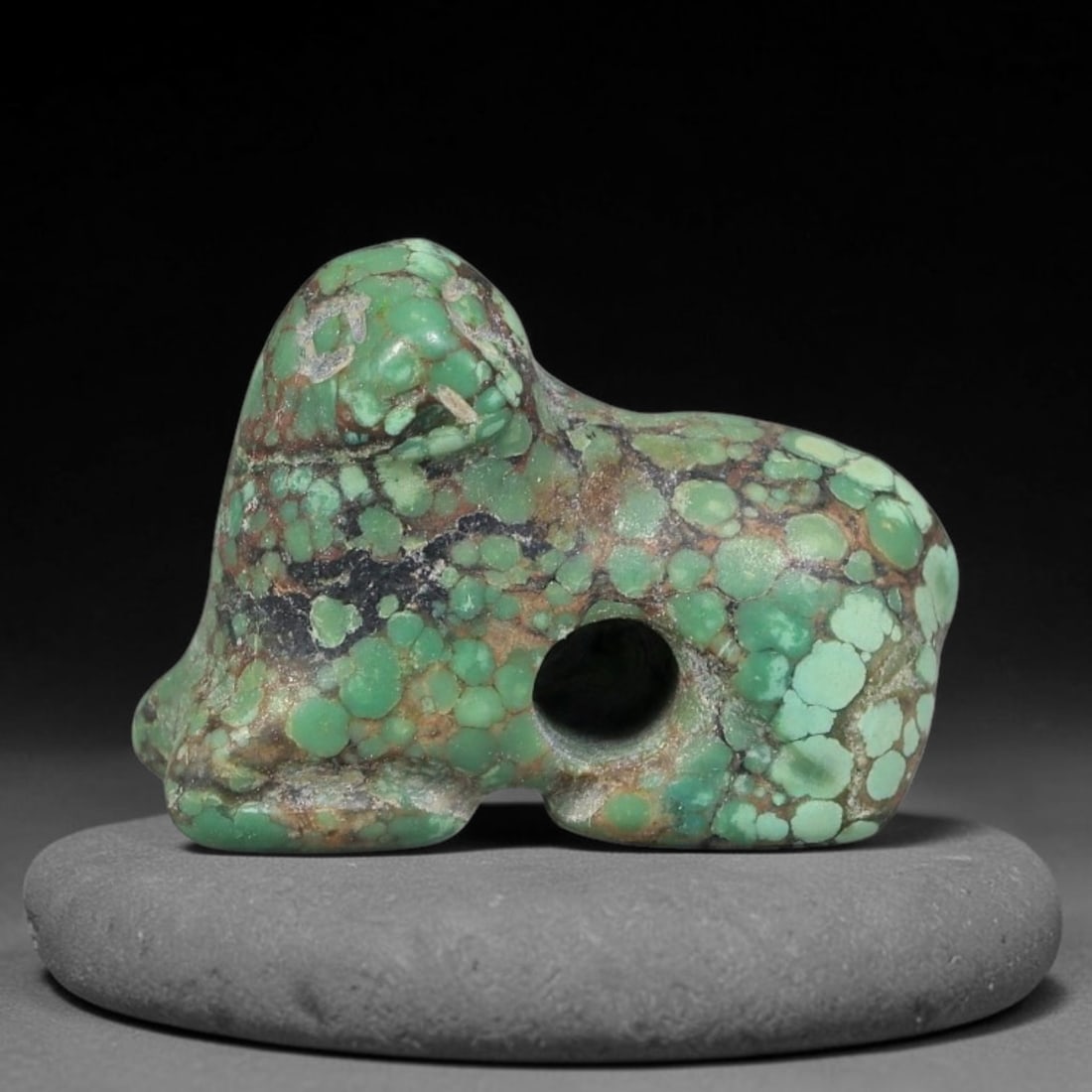 Ancient Sasanian Persian Turquoise Feline Amulet Bead (224-651 CE), 6EC: This antique recumbent feline amulet bead carved from natural turquoise originates from the Sasanian Persian Empire, where zoomorphic talismans represented guardianship and spiritual protection for th