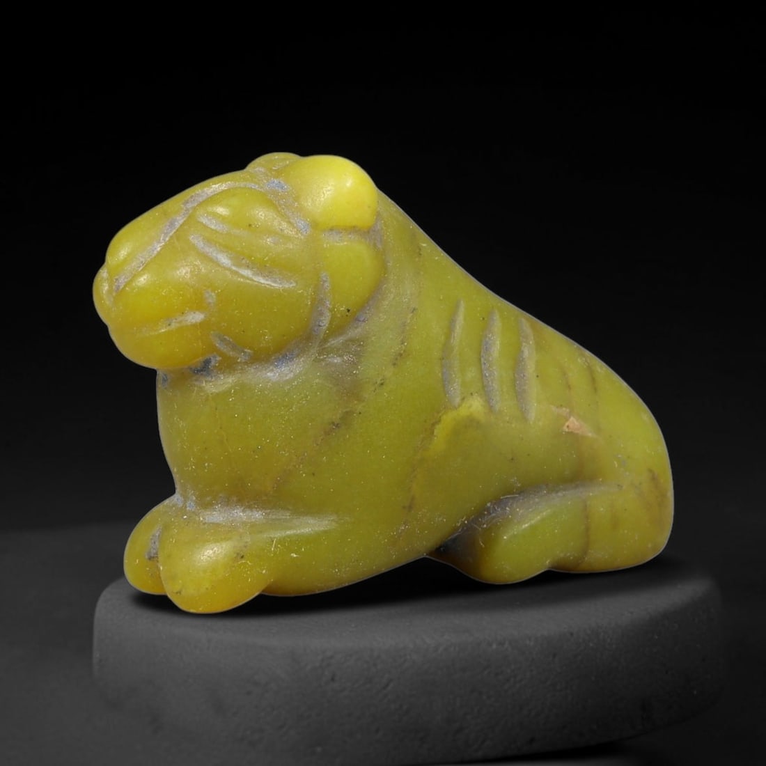 Ancient Sasanian Persian Feline Amulet Bead (224-651 CE), 57FV: This antique recumbent feline amulet bead originates from the Sasanian Persian Empire, where zoomorphic talismans were carved for elite personal protection and Zoroastrian devotional use. The stone is