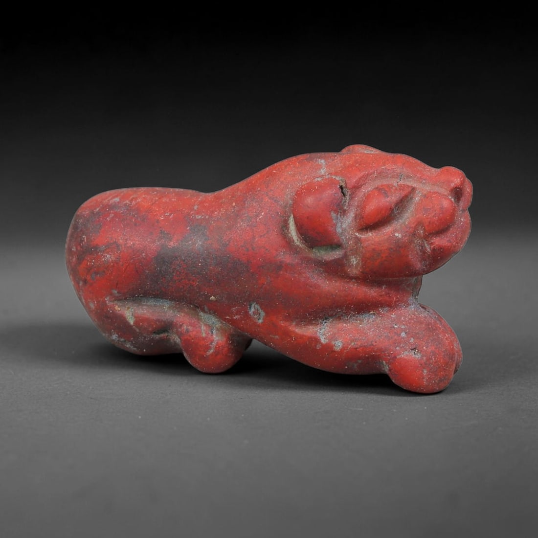 Ancient Achaemenid Persian Empire Red Jasper Recumbent Feline Amulet (550-330 BCE), 2EC: This carved red jasper recumbent feline amulet originates from the Achaemenid Persian Empire, a major Near Eastern power that created zoomorphic stone talismans signifying guardianship, royal strength