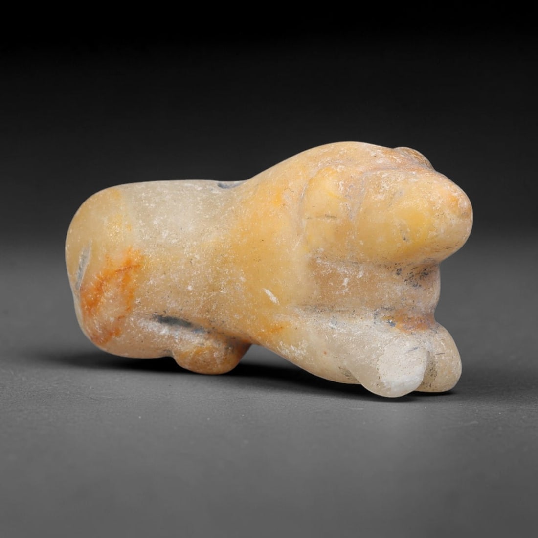 Ancient Assyrian Civilization Pale Quartz Recumbent Feline Amulet (2500-609 BCE), 60FV: This carved pale quartz recumbent feline amulet originates from Ancient Assyrian Civilization of the ancient Near East, where feline zoomorphic talismans symbolized royal authority, protection and for