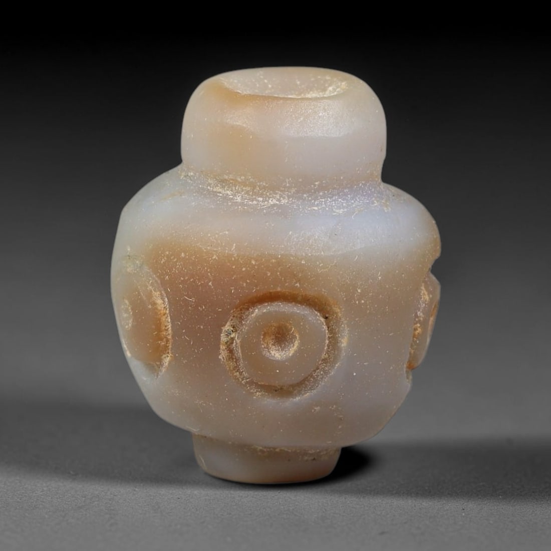 Ancient Sasanian Persian Empire Banded Agate Eye Bead (224-651 CE), 9EC: This banded agate eye bead originates from the Sasanian Persian Empire, with raised concentric circular eye motifs that functioned as powerful protective talismans to ward off negative forces within a