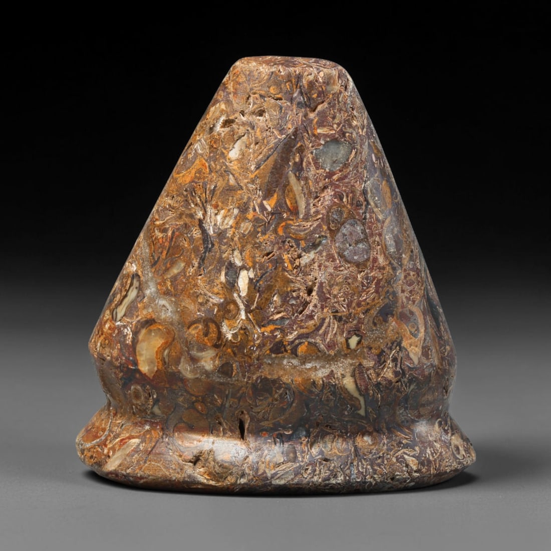 Ancient Medieval Mamluk Fossil Stone Talisman Ornament (1250-1517 CE), 73ED: This antique unperforated fossil stone talisman ornament originates from the Mamluk cultural sphere, created as a powerful protective decorative amulet. The conical form showcases striking natural tex