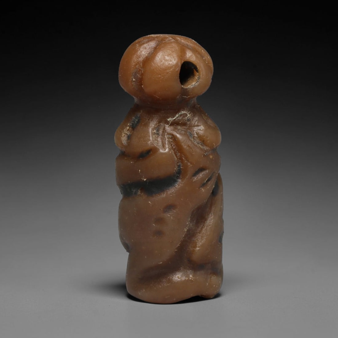 Ancient Sasanian Persian Cylinder Seal (c.224-651 CE), 21ED: This carved brown stone cylinder seal originates from Ancient Sasanian Persian culture. Continuous modelled imagery encircles the cylindrical body, crafted within established regional artistic traditi
