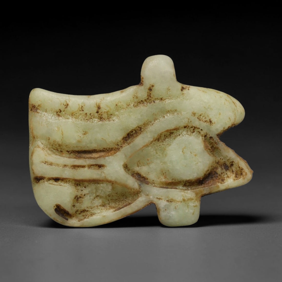 Ancient Predynastic & Pharaonic Egyptian Wedjat Eye Amulet (4000 BCE-30 CE), 34ED: This carved pale stone Wedjat Eye amulet originates from Pharaonic Egyptian Civilization, the iconic symbol of healing, protection and cosmic equilibrium within ancient Egyptian funerary and devotiona