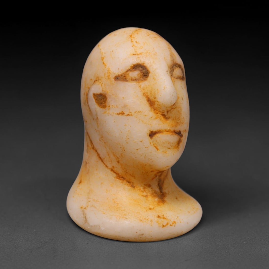 Ancient Bactrian Marble Idol Head (250 BCE-200 CE), 39ED: This carved pale marble idol head originates from Greco-Bactrian Culture, a significant Silk Road civilization blending Hellenistic and Central Asian artistic traditions. The simplified facial feature