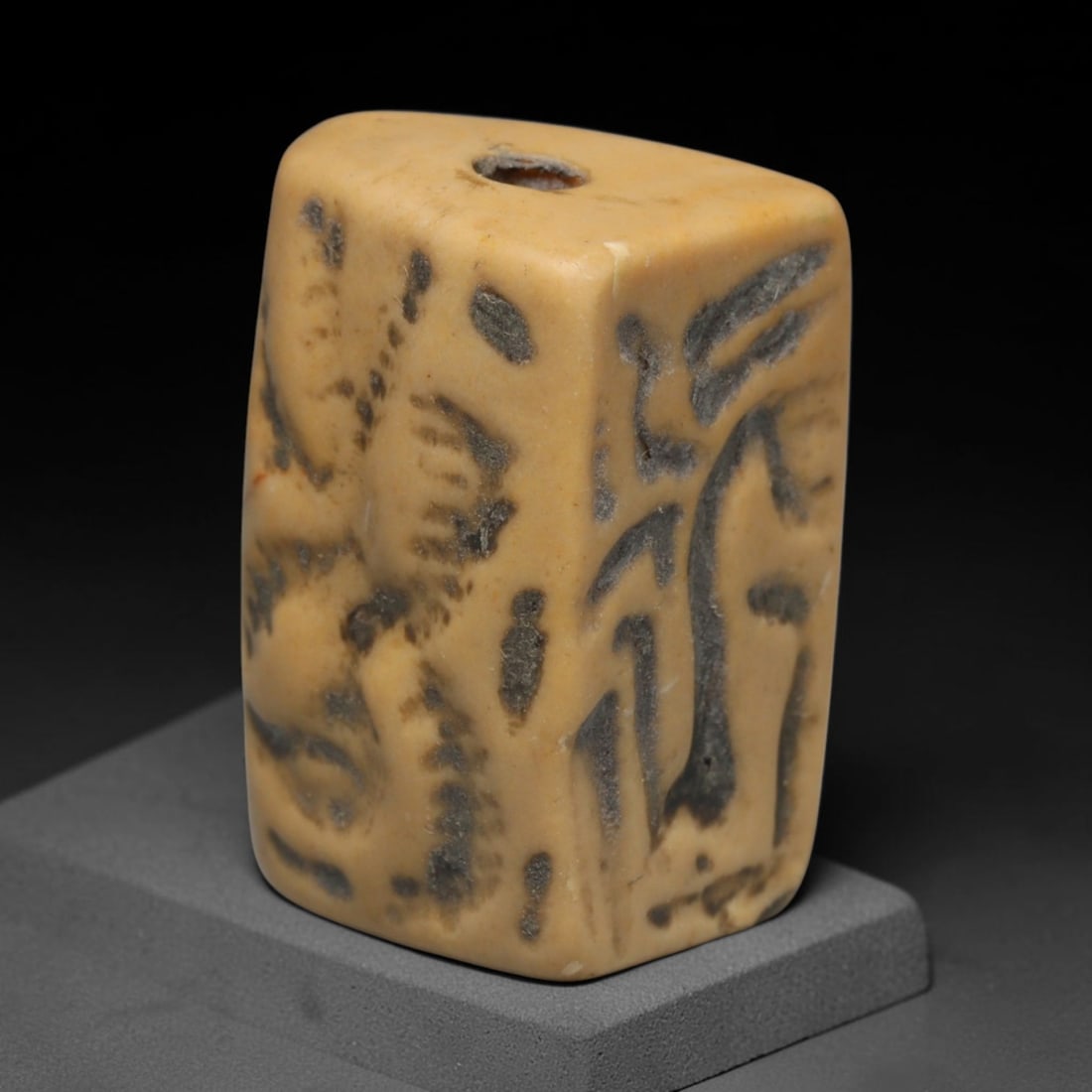 Ancient Sasanian Persian Rectangular Prism Stamp Seal (c.224-651 CE), 45ED: This cream variegated stone prism stamp seal originates from Ancient Sasanian Persian culture. Multiple faces are carved with figural motifs in classic Sasanian iconographic style. A central longitudi