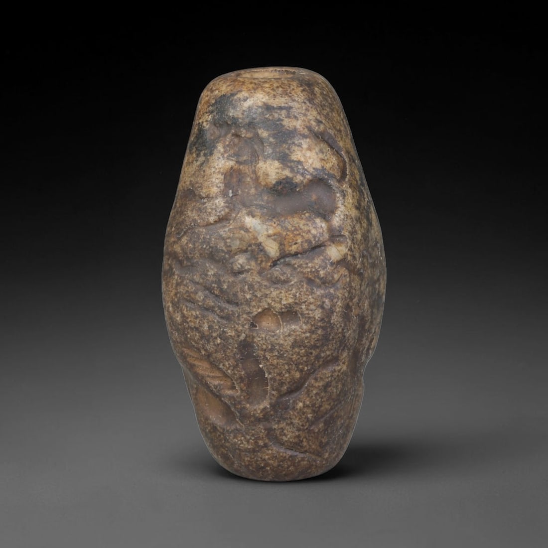 Ancient Mesopotamian Barrel-Shaped Cylinder Seal (c. Early Mesopotamian Period), 49EF: This variegated earth-toned barrel-style cylinder seal originates from Ancient Mesopotamia. The exterior surface carries deeply carved relief figural scenes, executed in traditional Mesopotamian seal 
