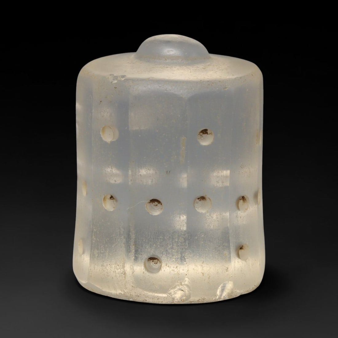 Ancient Medieval Mamluk Dotted Clear Glass Talisman Bead (1250-1517 CE), 61ED: This antique cylindrical glass talisman bead originates from the Mamluk realm, made for personal adornment and protective talismanic use. The translucent pale glass body features vertical faceting and
