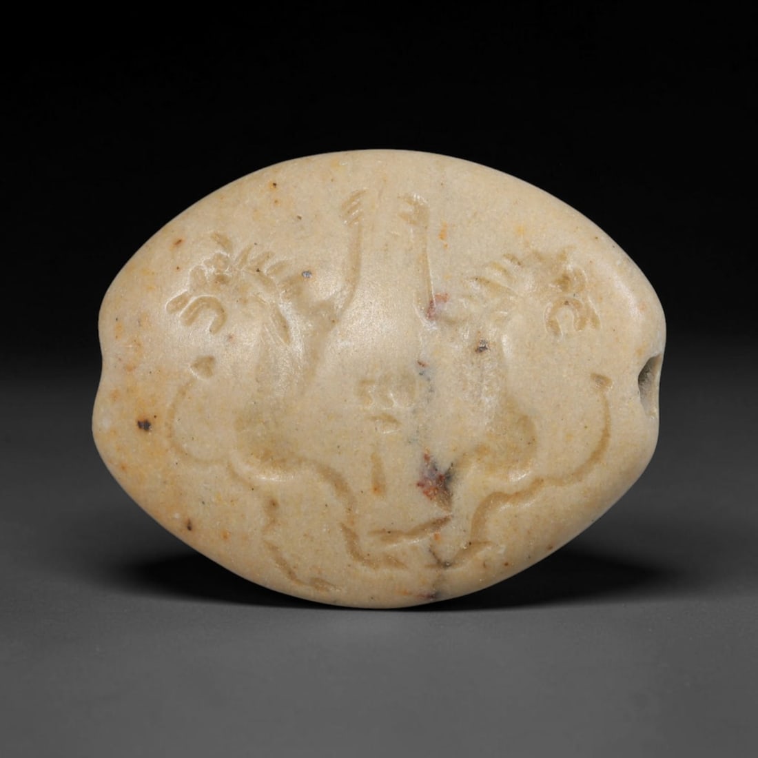 Ancient Sasanian Persian Intaglio Bead (c.224-651 CE), 79ED: This pale stone oval intaglio bead originates from Ancient Sasanian Persian culture. The front face carries finely incised figural intaglio imagery crafted in traditional Sasanian artistic style. A tr