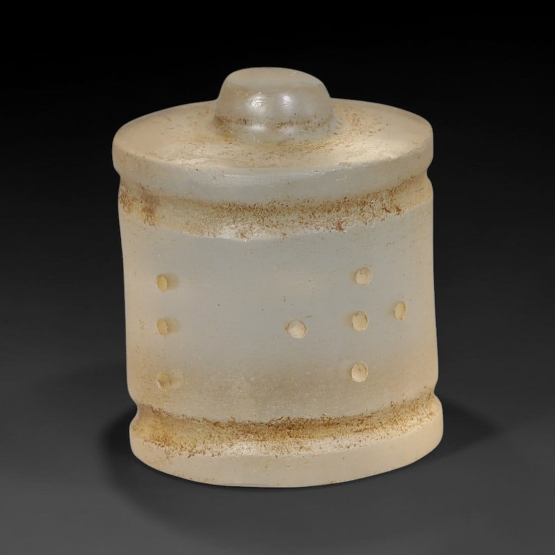 Ancient Mamluk Carved Glass Talisman Amulet (c.1250-1517 CE), 93ED: This pale opaque glass talisman originates from the Mamluk period. Shaped as a compact cylindrical form with a domed knob finial, its exterior is decorated with orderly punctate dot motifs framed by r