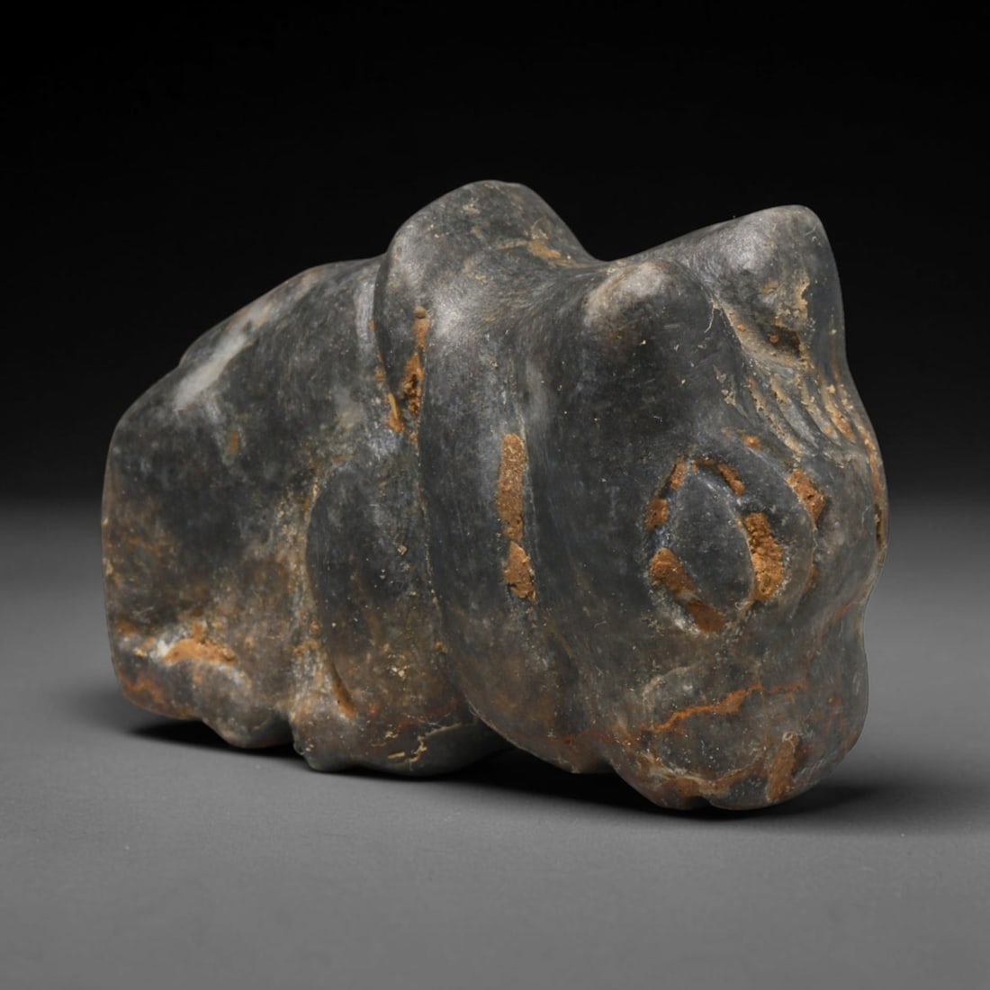 Ancient Sasanian Persian Bovine Effigy Amulet (224-651 CE), 67ED: This carved dark stone bovine effigy originates from the Sasanian Persian Empire, where bovine motifs held profound Zoroastrian ritual significance as protective talismans. The piece bears characteris