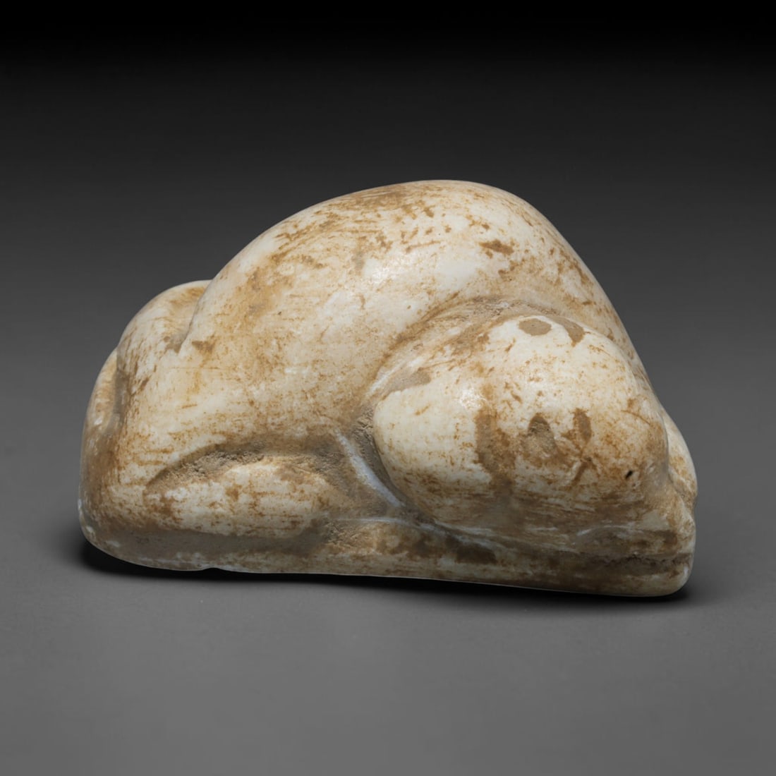 Ancient Bactrian Recumbent Bovid Effigy (250 BCE-200 CE), 50ED: This carved pale stone recumbent bovid effigy originates from Greco-Bactrian Culture, a historic Silk Road civilization combining Hellenistic and Central Asian artistic styles. The creature is modelle
