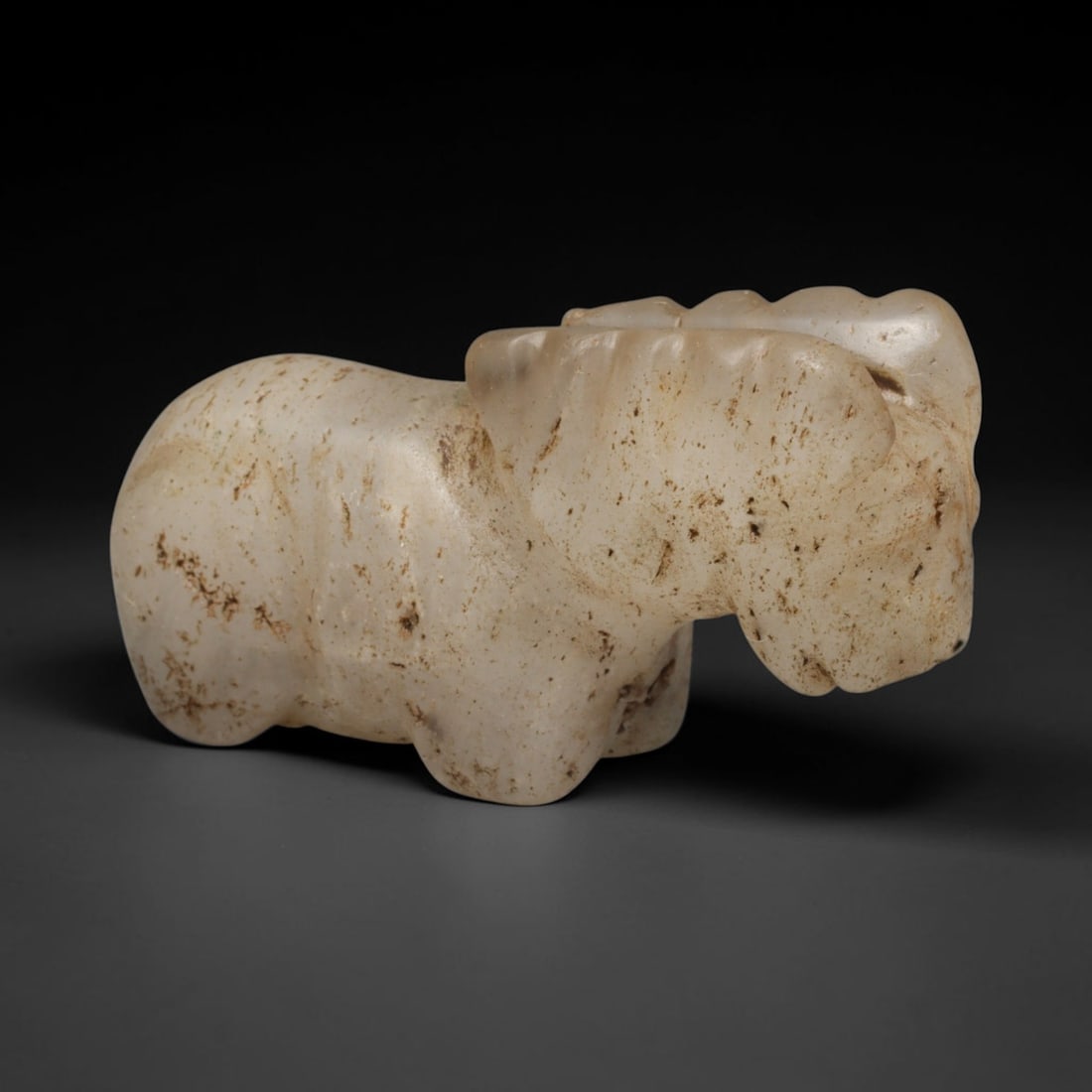 Ancient Sasanian Persian Rock Crystal Ram Effigy Amulet (c.224-651 CE), 29ED: This translucent rock crystal ram effigy originates from Ancient Sasanian Persian culture. Rendered in a recumbent pose with stylised horn detailing, the piece retains natural inclusions and scattered