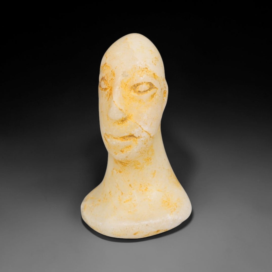 Ancient Bactrian Marble Idol Head (250 BCE-200 CE), 3EF: This carved pale marble idol head originates from Greco-Bactrian Culture, a significant Silk Road civilization blending Hellenistic and Central Asian artistic traditions. The simplified facial feature