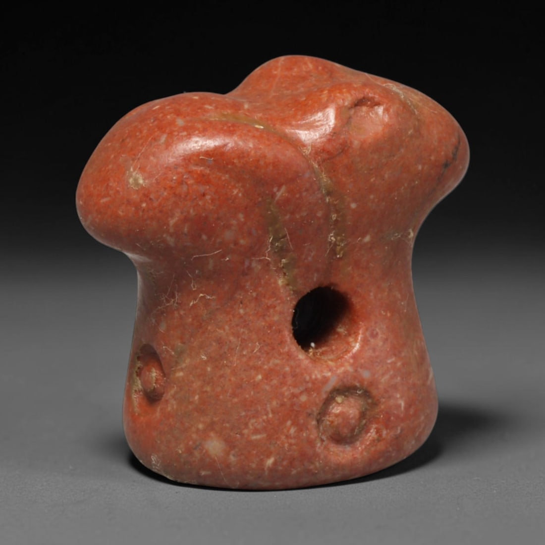 Ancient Sasanian Persian Red Stone Double Zoomorphic Head Stamp Seal (224-651 CE), 49ED: This antique red speckled stone double zoomorphic head stamp seal originates from Ancient Sasanian Persian civilisation, functioning both as a tool for creating clay impressions and a protective weara