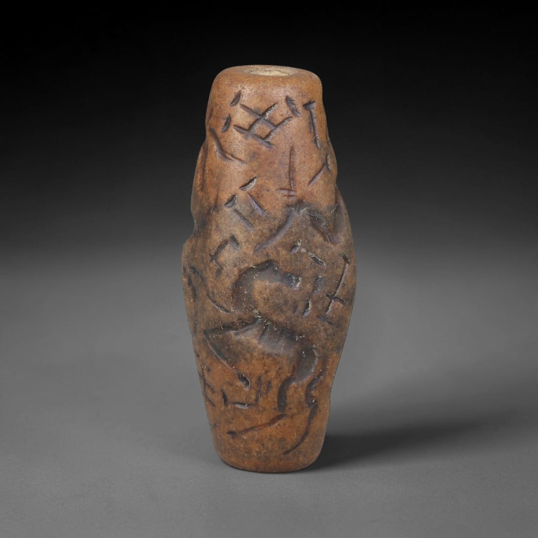 Ancient Sasanian Persian Carved Stone Cylinder Amulet (224-651 CE), 53EF: This antique carved stone cylinder amulet originates from the Sasanian Persian Empire, famed for zoomorphic talismanic carvings crafted for personal protection across late antique Western Asia. The da