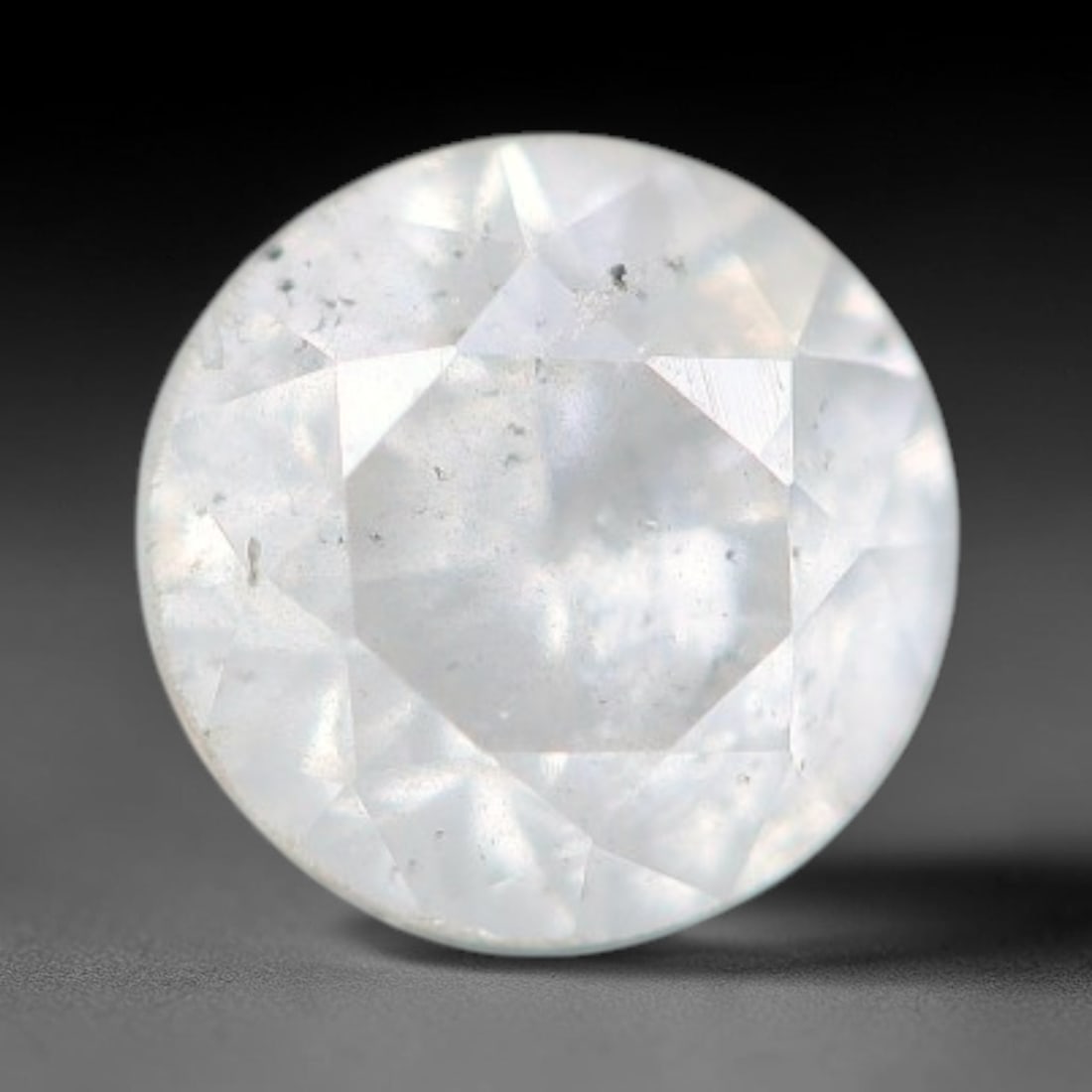 0.23ct Round Natural Fancy Greenish Yellow Diamond Loose Gemstone, 58BH: This polished natural round fancy diamond displays a delicate greenish-yellow base tone, with scattered fine native mineral specks distributed within its crystalline interior, measured at calibrated d