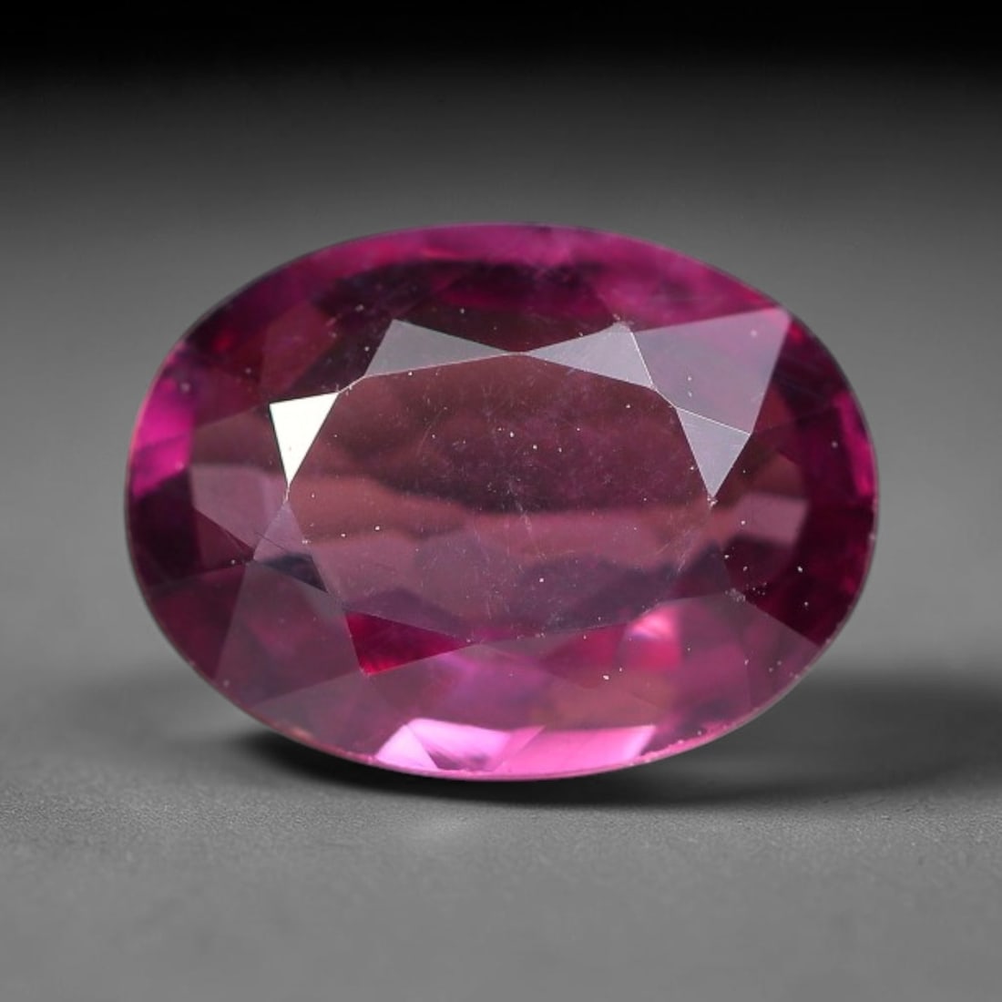 1.13ct Natural Tanzanian Rhodolite Grape Garnet Faceted Loose Gemstone, 85BF: This expertly faceted grape garnet, a scarce saturated purple-magenta rhodolite variant, features transparent crystal structure dotted with faint microscopic mineral specks within its precisely cut re