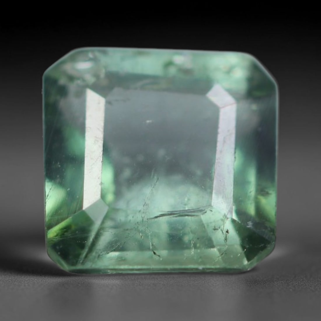 1.03 Carats Natural Mozambique Pale Mint Green Tourmaline Loose Gemstone, 53AK: This transparent Mozambique tourmaline displays a soft pale mint green hue, with natural fine internal fissures and subtle scattered mineral specks within the crystal, dimensions 6.1x6.1x3.4mm. Mozamb