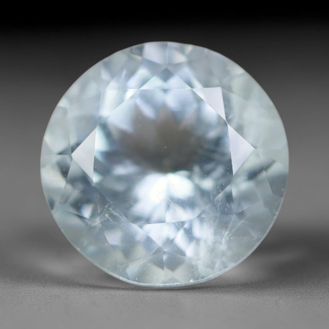 3.85ct Natural Brazilian Sky Blue Faceted Aquamarine Loose Gemstone, 14BC: This precisely faceted aquamarine boasts clear translucent pale sky blue body tone with subtle thin mineral needle and tiny scattered crystalline specks visible within its polished reflective planes i