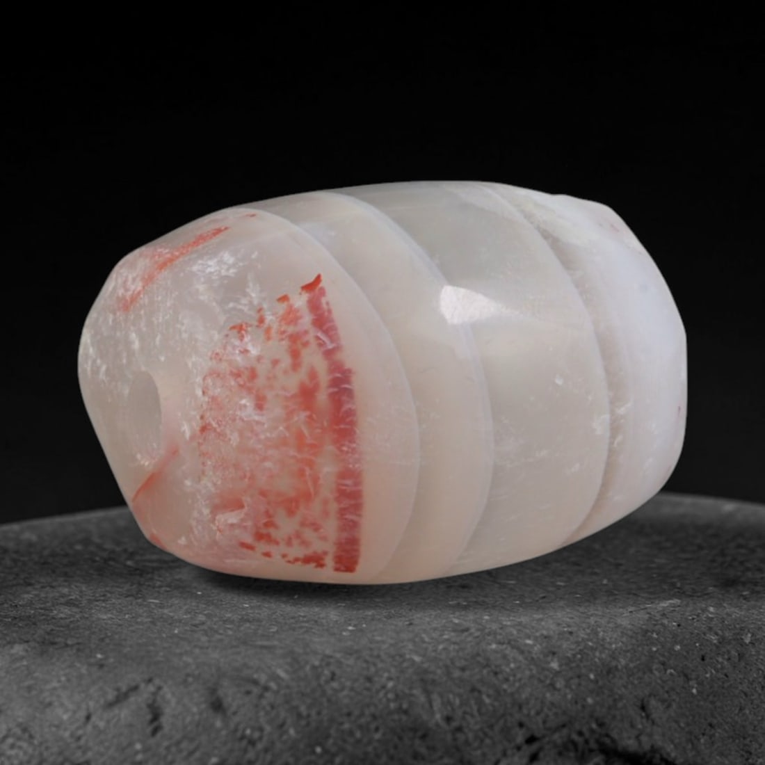 Ancient Kushan Empire Banded Agate Barrel Bead (30 CE-375 CE), 10AD: This antique banded agate barrel bead originates from the Kushan Empire, a cross-continental Central Asian realm that unified South and Central Asian bead craft traditions, supplying banded chalcedony
