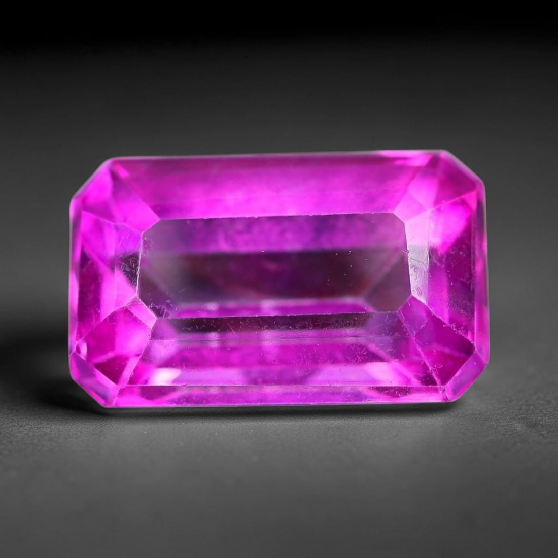 5.60 Carats Natural Brazil Hot Pink Topaz Loose Gemstone, 11FE: This natural Brazil topaz holds dimension measurements of 12.4x7.5x5.8mm, displaying an intense vibrant hot pink shade created through surface color coating treatment, its transparent crystal body car