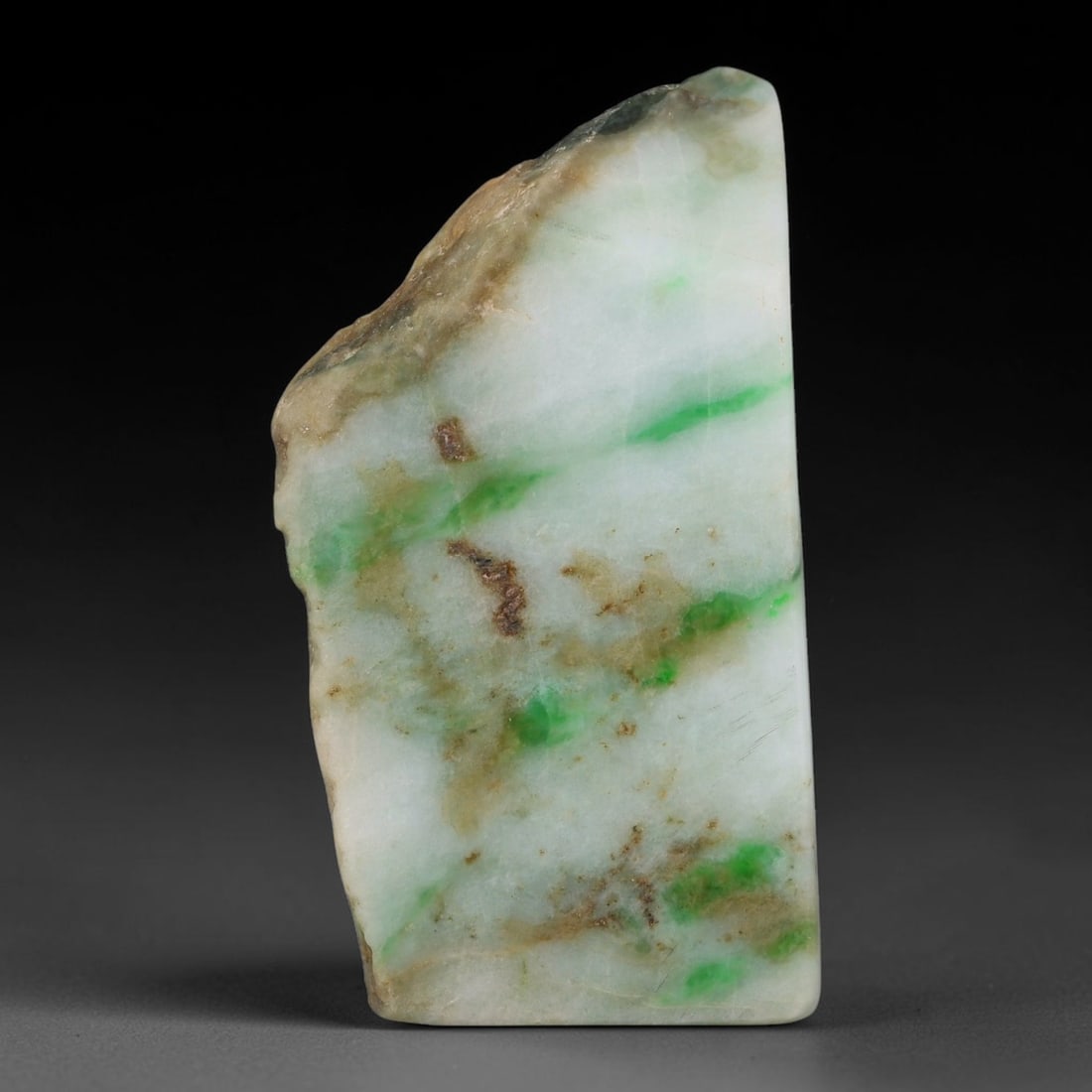 275ct Natural Type A Burmese Jadeite Jade Sliced Rough, 60FB: This specimen is a sliced rough block of natural Type A Burmese jadeite jade. The interior displays natural colour zoning with visible mineral veining and crystalline patterns typical of unprocessed j