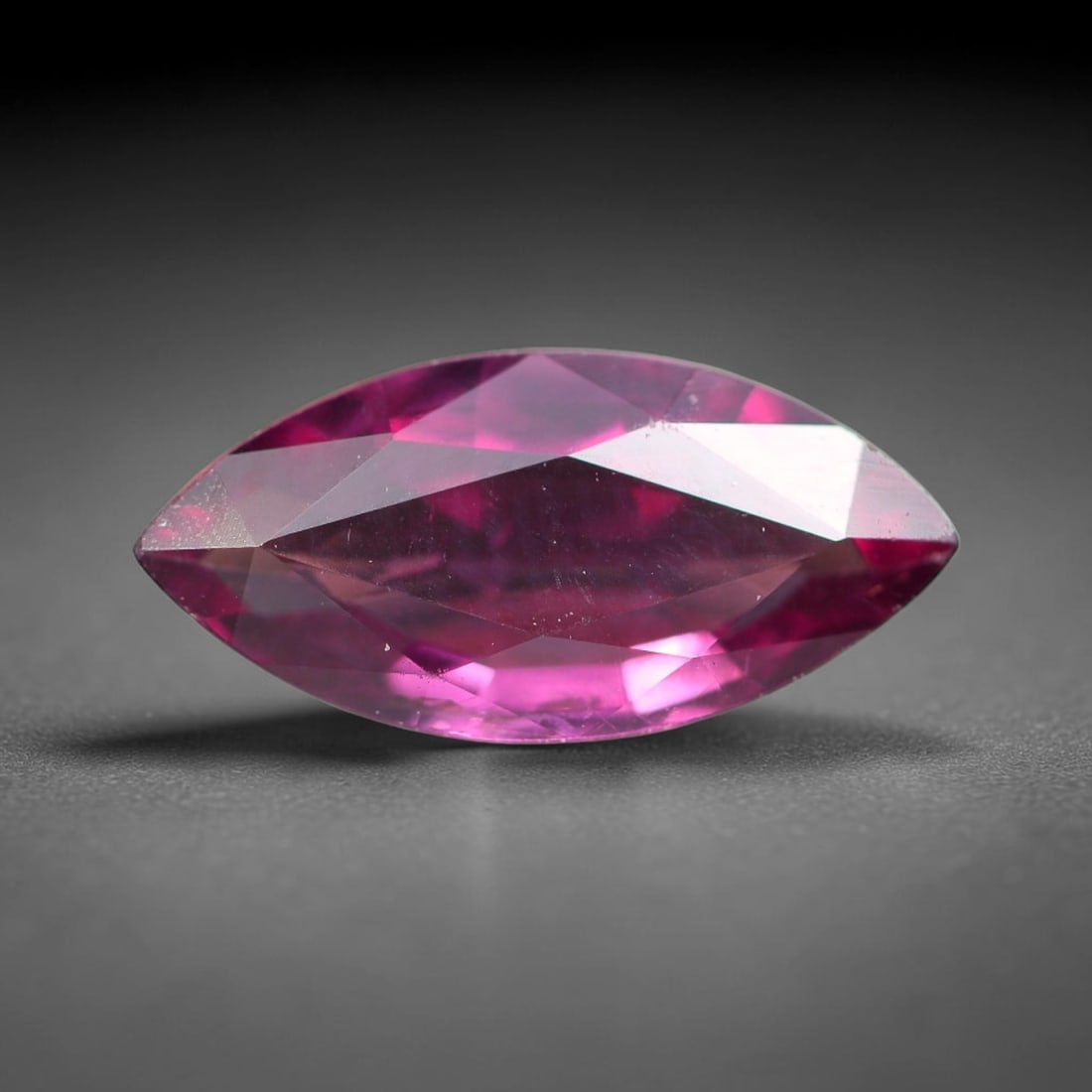 1.30ct Natural Tanzanian Rhodolite Grape Garnet Faceted Loose Gemstone, 97BF: This expertly faceted grape garnet, a scarce saturated purple-magenta rhodolite variant, features transparent crystal structure dotted with faint microscopic mineral specks within its precisely cut re