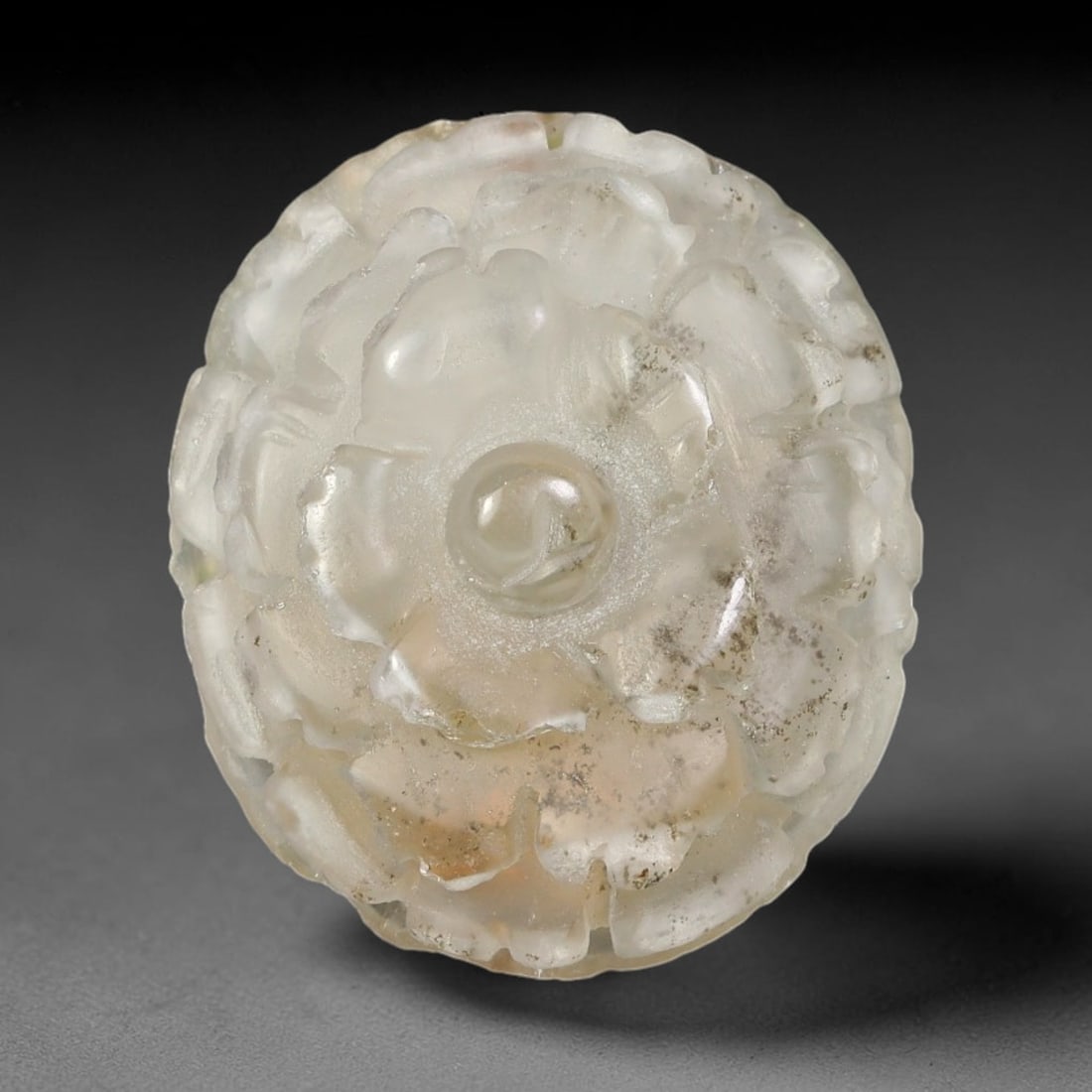 Natural Brazilian Phantom Quartz Hand Carved Floral Gemstone, 100BQ: This hand-carved floral specimen is crafted from natural phantom quartz. Intricate layered floral detailing wraps across the stone's surface, while translucent quartz matrix reveals subtle internal ph
