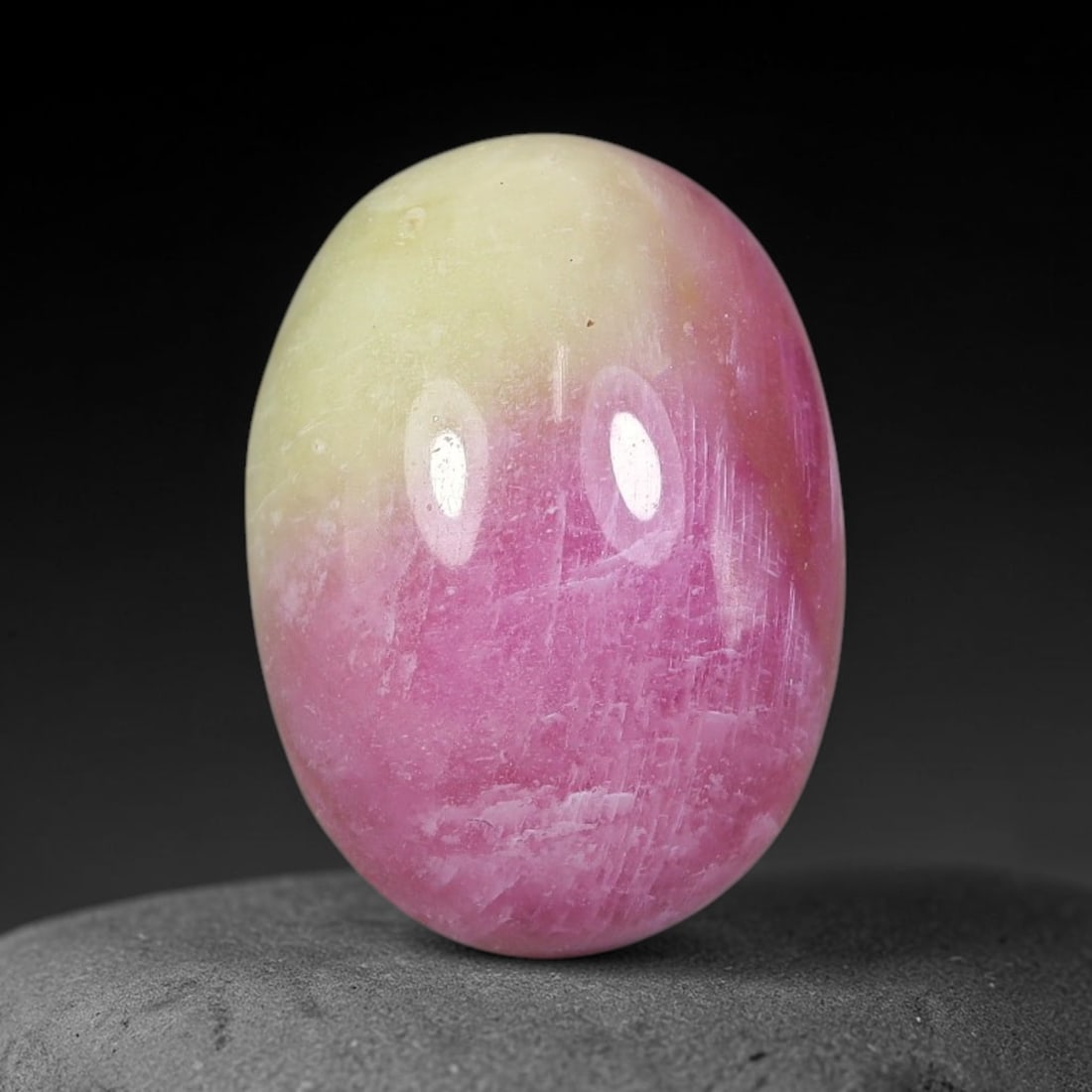 12.21 Carats Natural Mozambique Bicolor Ruby Loose Gemstone, 46FG: This natural Mozambique bicolor ruby cabochon holds dimension measurements of 14.5x10.6x7.1mm, displaying soft swirled intermix of rich pink and pale creamy mineral tones that blend seamlessly across 