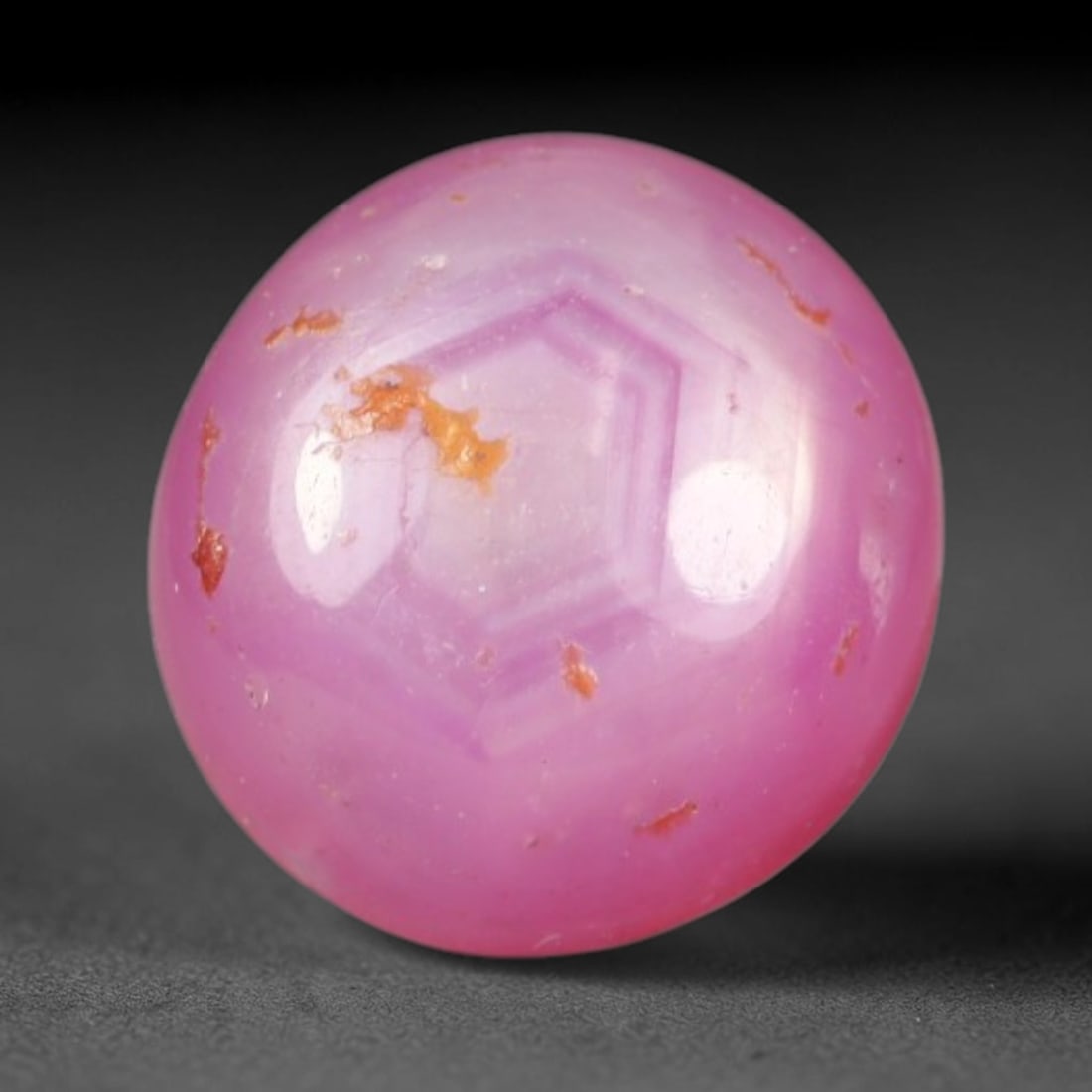 1.82ct Natural Mozambican Soft Bubblegum Pink Ruby Cabochon Loose Gemstone, 93AR: This smoothly polished domed ruby cabochon displays a gentle soft bubblegum pink body tone with faint natural linear mineral veining and tiny scattered rust-hued mineral flecks embedded within its tra