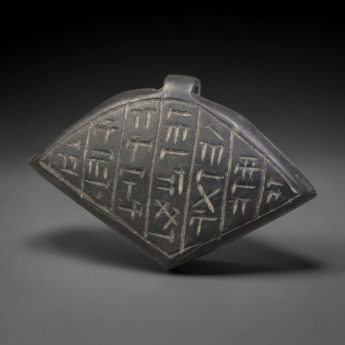 Vintage Uruk Revival Carved Stone Cuneiform Talisman Pendant Plaque, 7FK: This vintage pendant is hand-carved from dark mineral stone, designed in revival style inspired by ancient Uruk glyptic traditions. The surface features neatly arranged horizontal bands of stylized cu