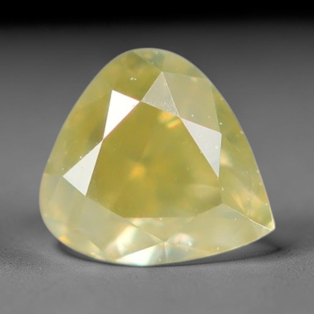 0.20ct Natural Untreated Fancy Greenish Yellow Diamond Loose Gemstone, 11BG: This polished natural diamond carries soft greenish-yellow body tone, with subtle microscopic mineral markings distributed throughout its crystalline interior, measured at calibrated dimensions of 3.5