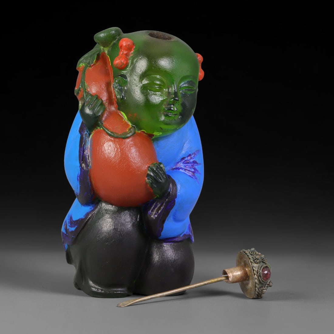 Vintage Chinese Liuli Glass Snuff Bottle - Boy Holding Gourd, 38AS: This snuff bottle is moulded from translucent green liuli glass, shaped as a young boy clutching a red gourd symbolizing good fortune. The garment is finished with hand-painted enamel in rich blue and