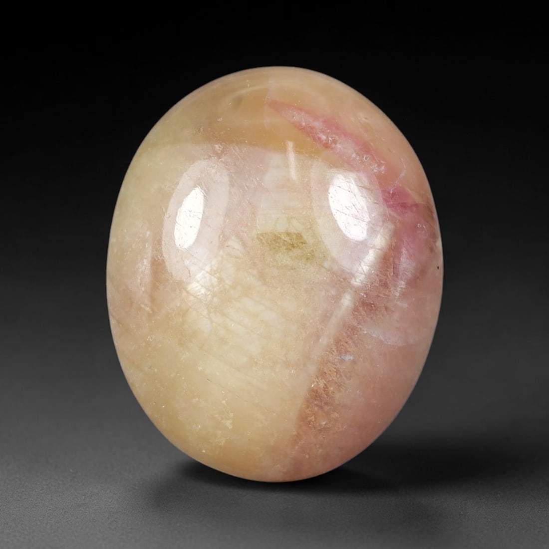 18.57 Carats Natural Madagascar Soft Rose Pink Heated Ruby Cabochon Loose Gemstone, 53FE: This warm blush-toned ruby cabochon carries blended swathes of soft rose pink and gentle peach undertones, with faint natural mineral veining throughout the polished dome, measured at 17.5x14.2x6.8mm.