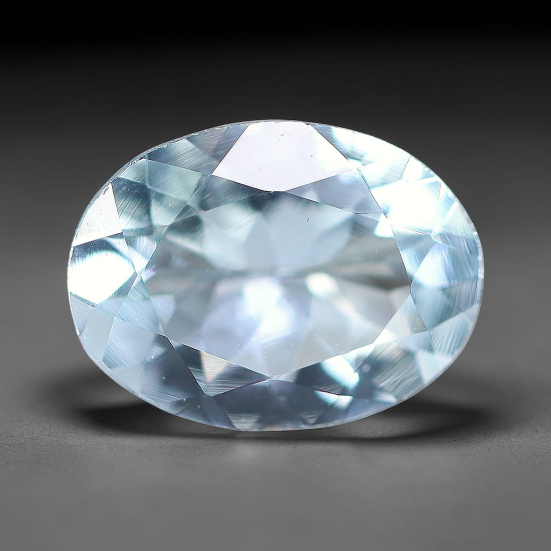 1.22ct Natural Brazilian Sky Blue Faceted Aquamarine Loose Gemstone, 1BF: This precisely faceted aquamarine boasts clear translucent pale sky blue body tone with subtle thin mineral needle and tiny scattered crystalline specks visible within its polished reflective planes i