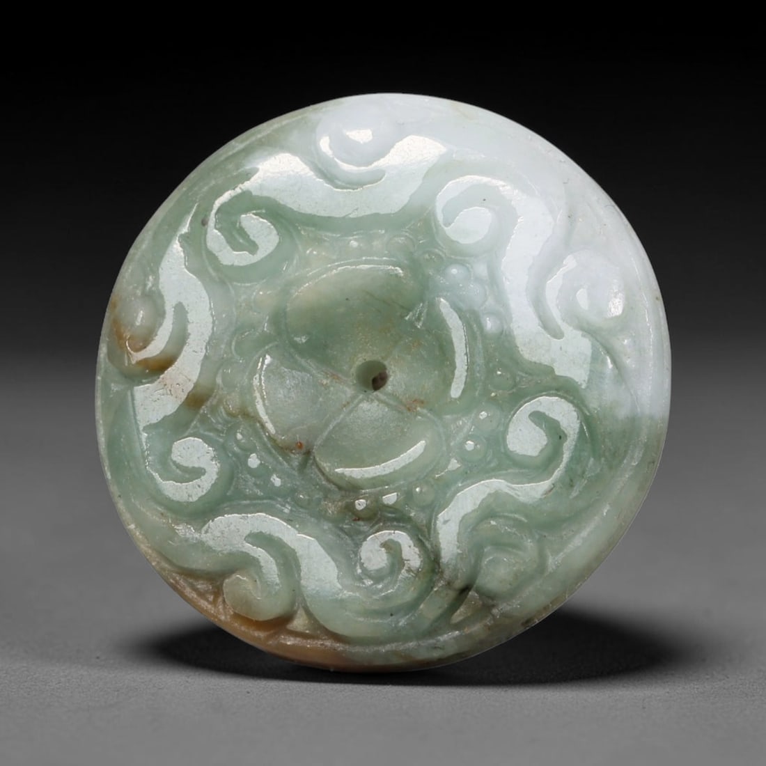 Natural Burmese Type A Jadeite Jade Carved Disc Pendant, 40BP: Artisan hand-carved untreated Burmese Type A jadeite jade circular disc pendant with a 26 mm diameter. The surface is adorned with detailed traditional relief carving finished with a smooth polished s