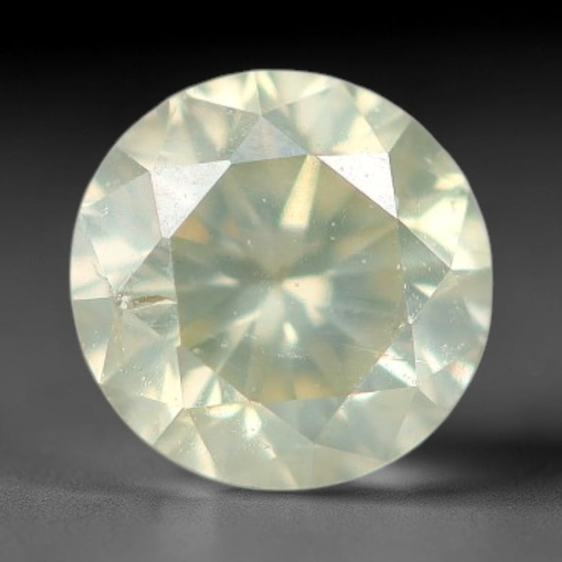 0.20ct Round Natural Fancy Greenish Yellow Diamond Loose Gemstone, 41BH: This polished natural round fancy diamond displays a delicate greenish-yellow base tone, with scattered fine native mineral specks distributed within its crystalline interior, measured at calibrated d