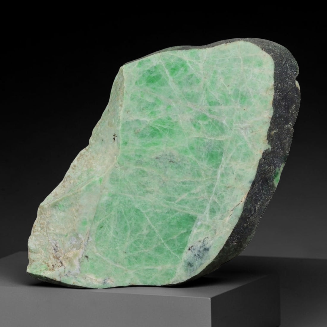 219ct Natural Type A Burmese Jadeite Jade Sliced Rough, 9AZ: This specimen is a sliced rough block of natural Type A Burmese jadeite jade. The interior displays natural colour zoning with visible mineral veining and crystalline patterns typical of unprocessed j